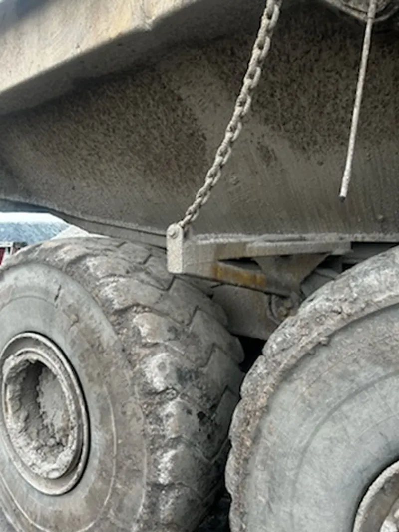 Packed mud and salt in the tires and undercarriage of a haul truck